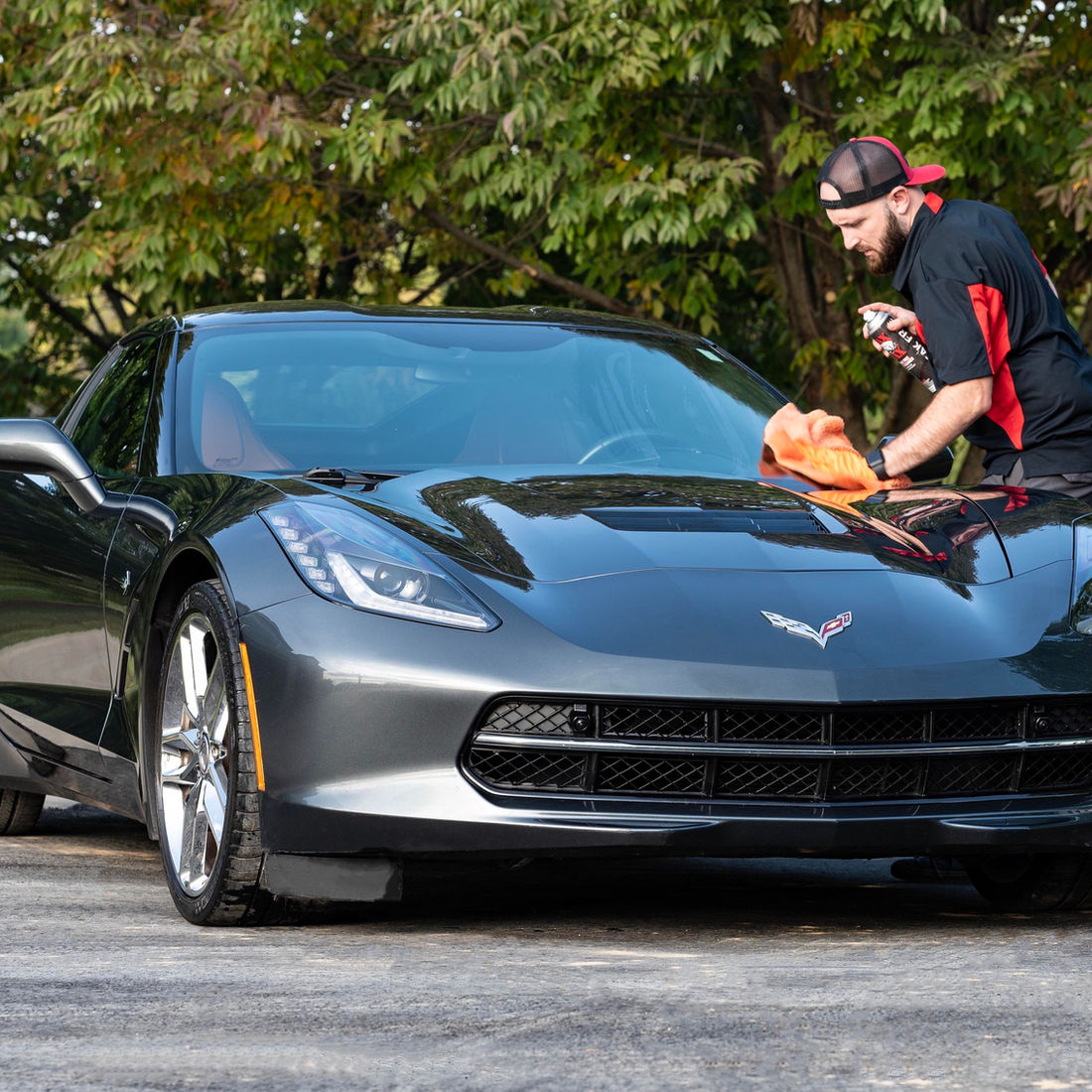 Grey Corvette being hand-detailed