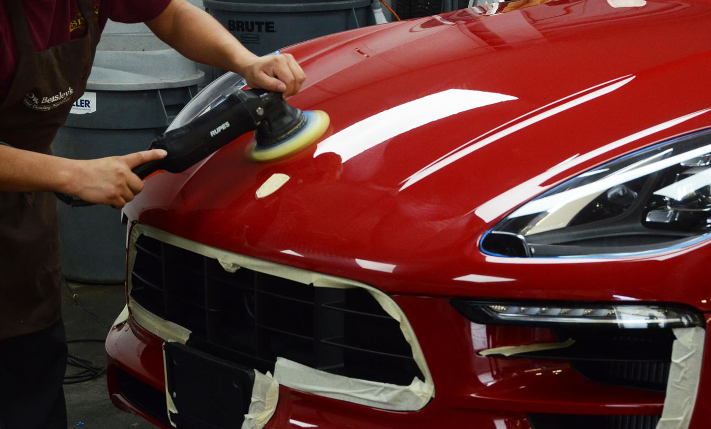 Machine polisher correcting red paint